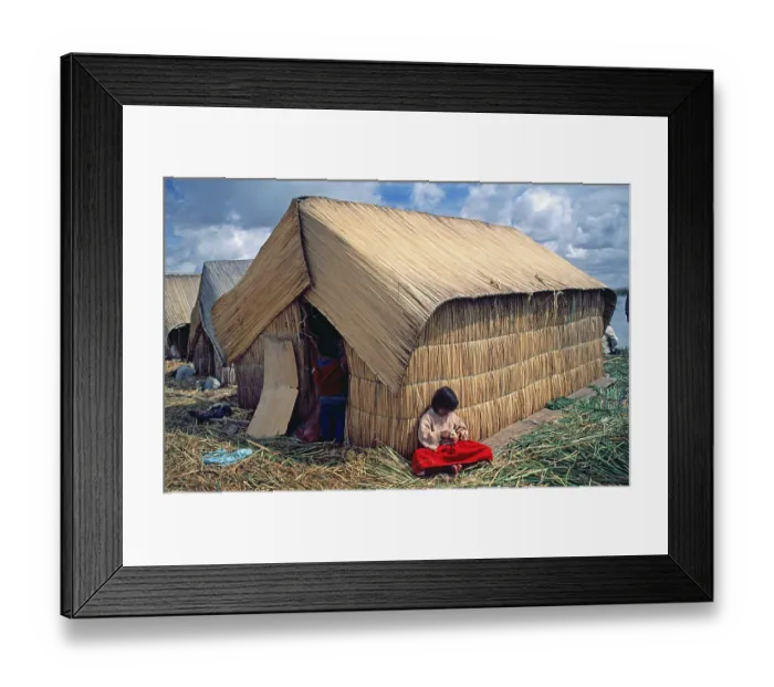 Framed Print : Little girl sitting in front of a reed hut on a floating Uro island in Lake Titcaca Framed Print : Little girl sitting in front of a reed hut on a floating Uro island in Lake Titcaca