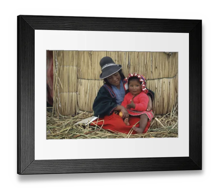 Framed Print : Children sitting in front of a reed hut on a floating Uro island in Lake Titcaca