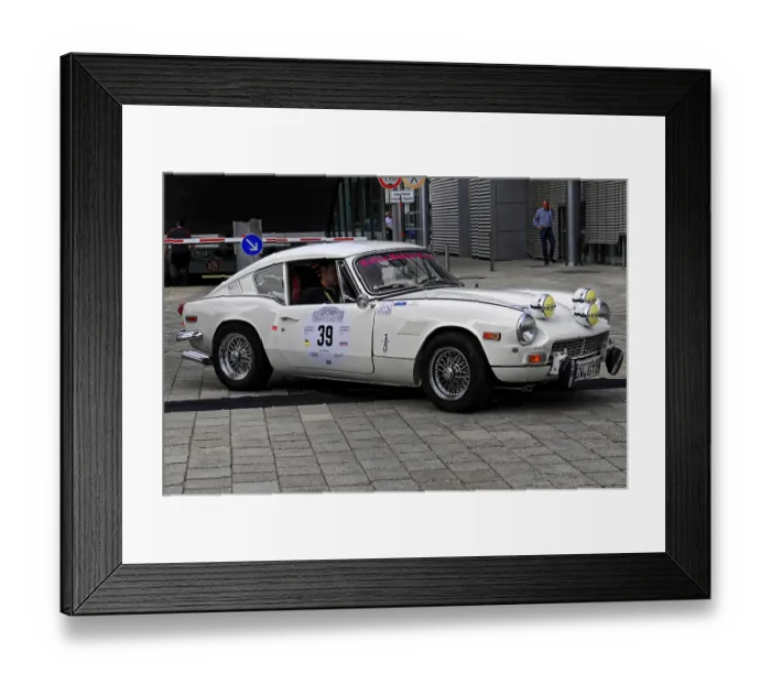 Framed Print : Triumph GT6, white classic car during a rally on cobblestones