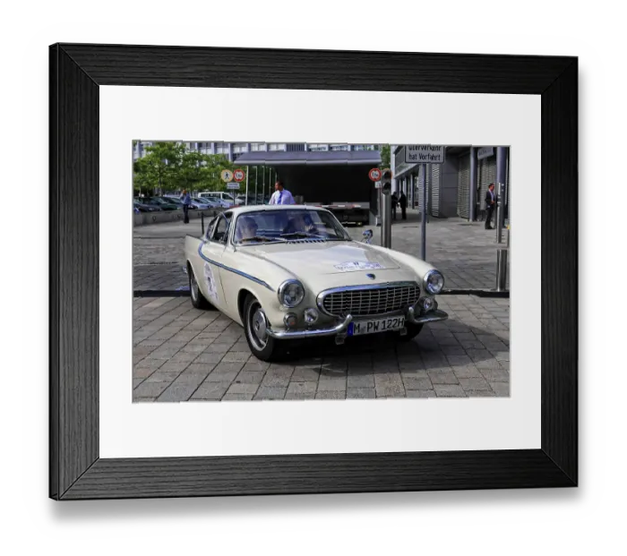 Framed Print : Elegant cream-colored classic car with curved lines and two occupants on a street Framed Print : Elegant cream-colored classic car with curved lines and two occupants on a street