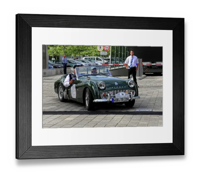 Framed Print : Green vintage convertible with two occupants driving on paved road Framed Print : Green vintage convertible with two occupants driving on paved road