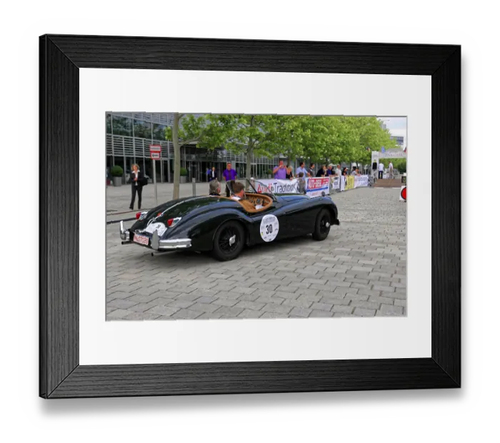 Framed Print : Black vintage convertible on event street with spectators