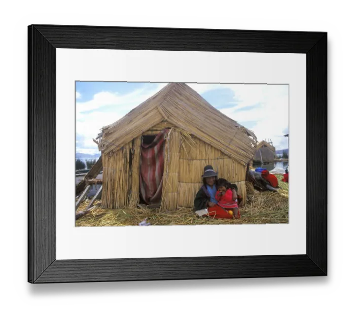Framed Print : Children sitting in front of a reed hut on a floating Uro island in Lake Titcaca