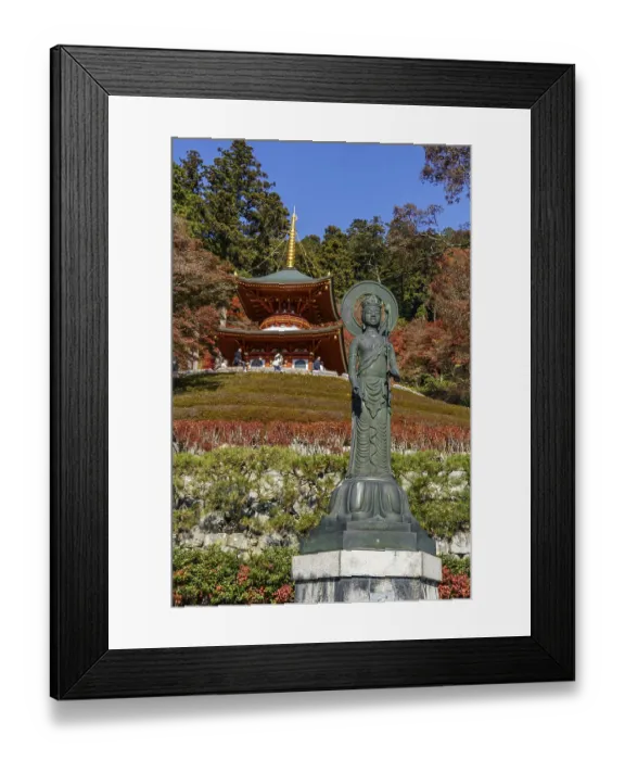Framed Print : Spiritual image of a Buddha statue in front of a temple surrounded by autumn trees