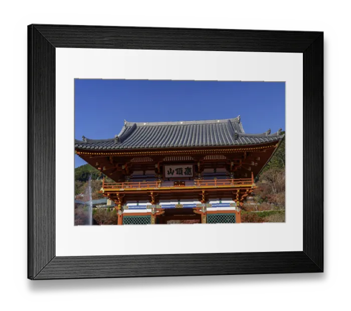 Framed Print : A traditionally designed Japanese temple building against a blue sky