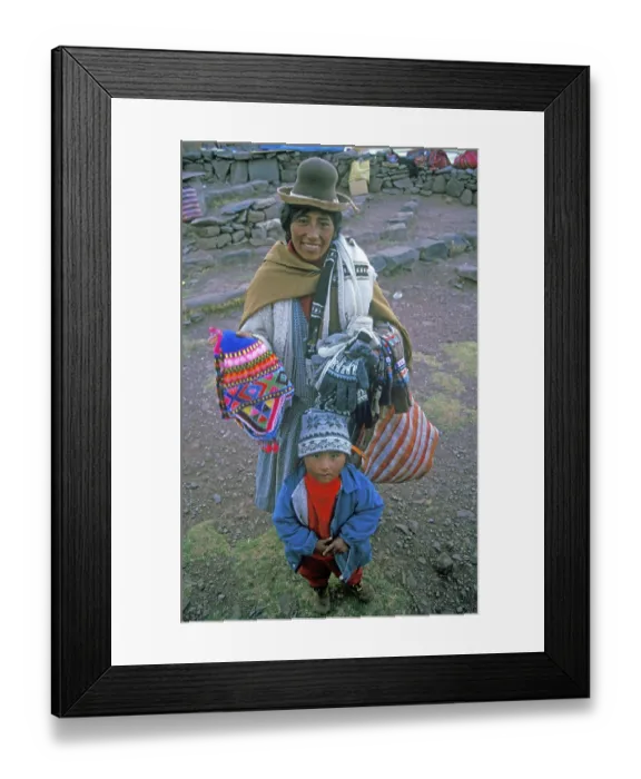 Framed Print : A woman with a small child sells souvenirs to tourists at the Sillustani ruins on Lake Umayo near Puno Framed Print : A woman with a small child sells souvenirs to tourists at the Sillustani ruins on Lake Umayo near Puno
