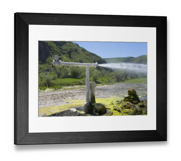 Framed Print : Natural water source with sparkling water jet against green mountain landscape