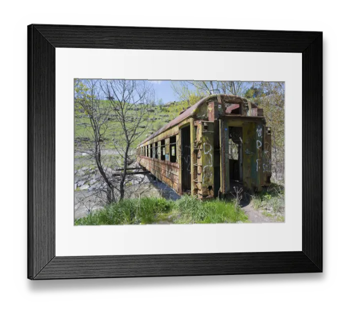 Framed Print : An abandoned, rusted drawbridge with graffiti in a green