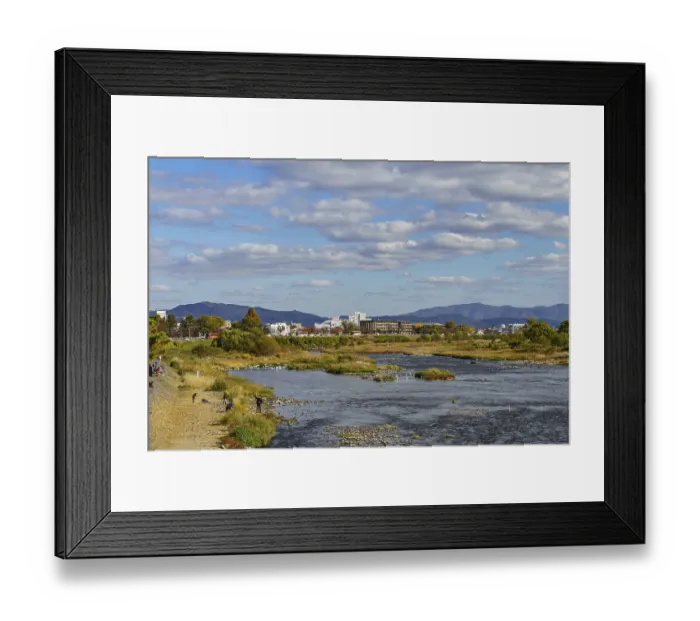 Framed Print : A river landscape with an urban background and picturesque mountains Framed Print : A river landscape with an urban background and picturesque mountains