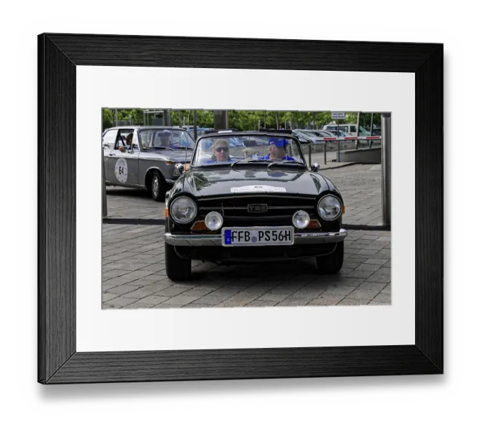 Framed Print : Black cabriolet classic car with two people in front view during a car event