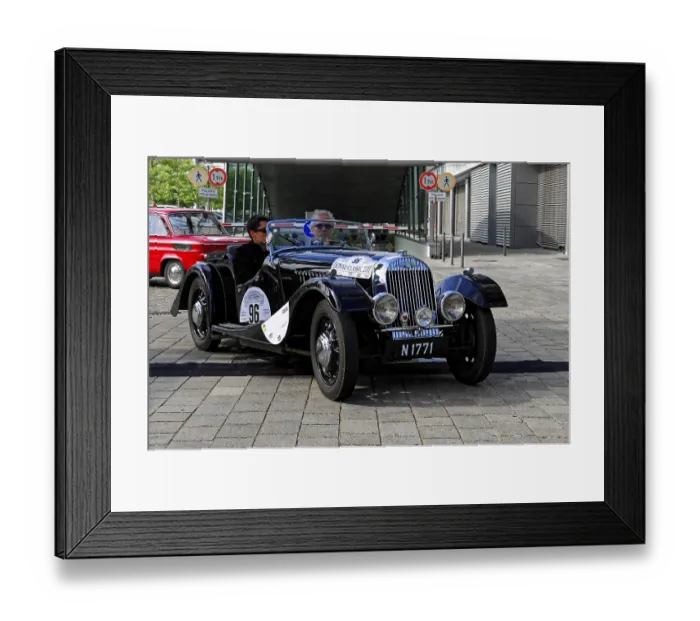 Framed Print : Morgan 4-4-2 Seater, black vintage convertible with two drivers on a paved road during a race Framed Print : Morgan 4-4-2 Seater, black vintage convertible with two drivers on a paved road during a race