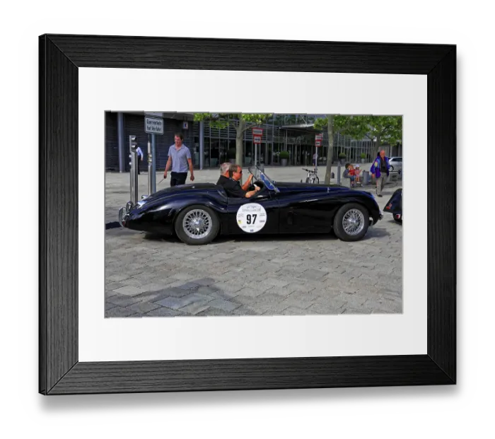 Framed Print : JAGUAR XK 120, black classic roadster with two men on a paved road