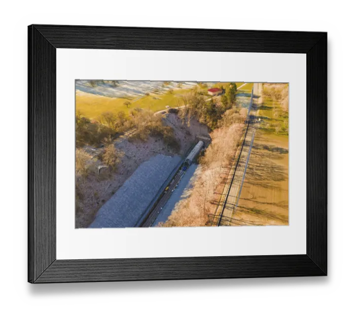 Framed Print : Drone view of a railway line through an autumn landscape with meadows and forests