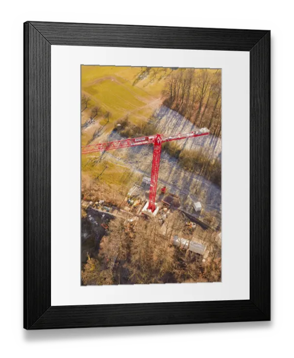 Framed Print : Red crane seen from the air on a construction site on the edge of a forest in an autumn landscape