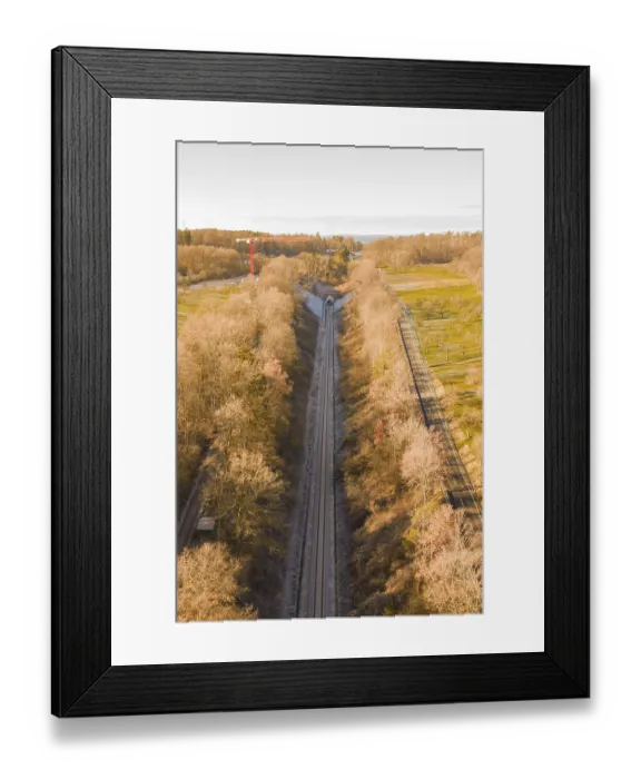 Framed Print : Aerial view of a train line through autumnal forests Framed Print : Aerial view of a train line through autumnal forests