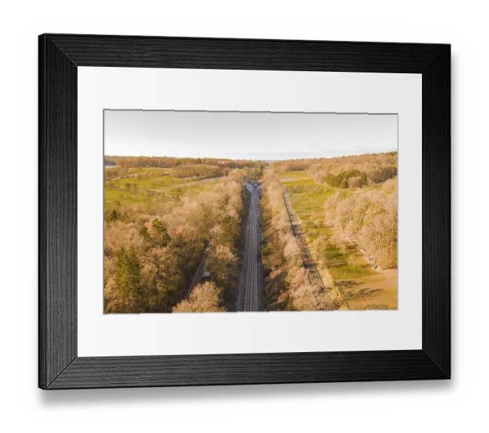 Framed Print : Train route from above, flanked by autumnal forests