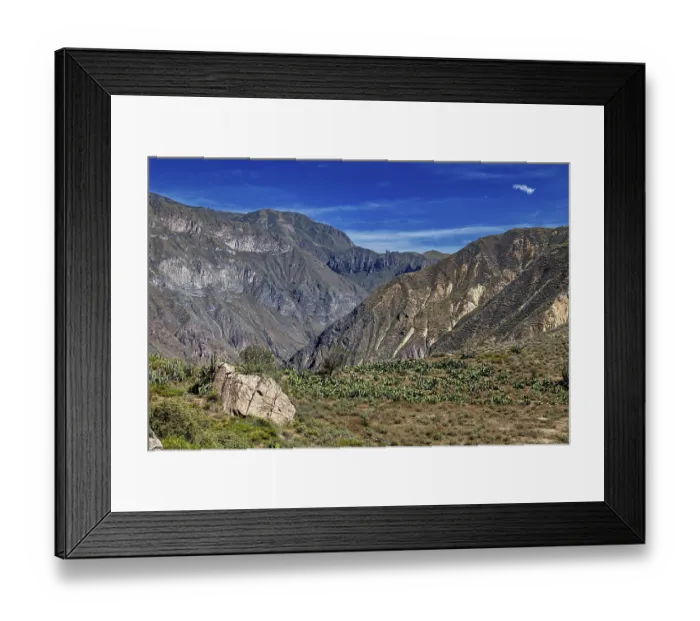 Framed Print : Wide mountain landscape with green vegetation under a clear sky