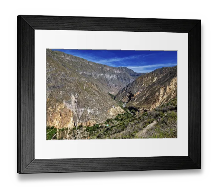 Framed Print : Extensive mountain landscape with a deep gorge under blue sky