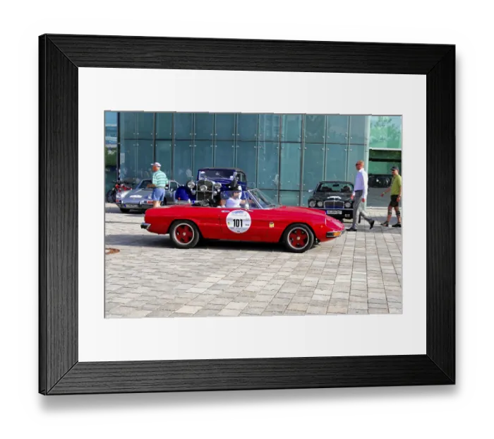 Framed Print : A red vintage convertible in front of a modern glass building at a car exhibition