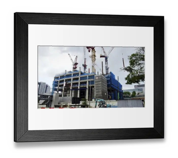 Framed Print : Construction site of a large building with several cranes under overcast sky Framed Print : Construction site of a large building with several cranes under overcast sky