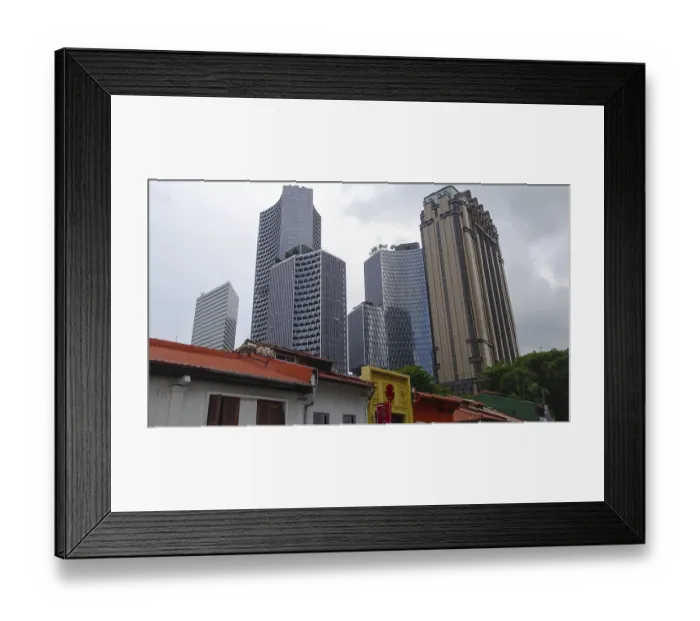 Framed Print : Modern skyscrapers tower over the rooftops of a city under a slightly cloudy sky Framed Print : Modern skyscrapers tower over the rooftops of a city under a slightly cloudy sky