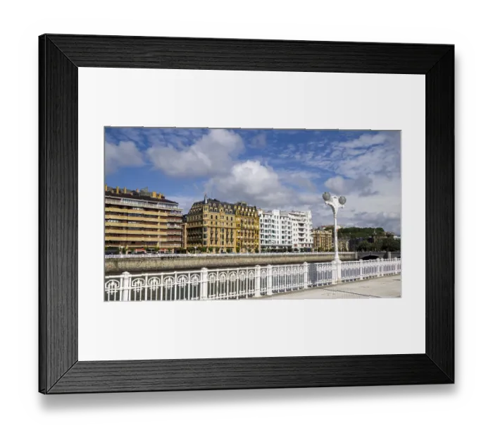 Framed Print : City landscape with classic building facades along a river and blue sky with clouds