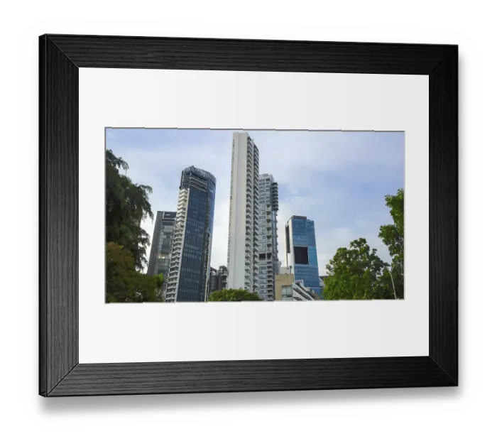 Framed Print : Towering modern skyscrapers with glass facades against a blue sky in an urban setting