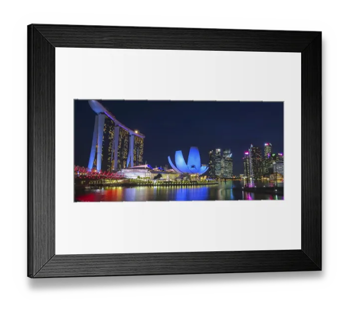 Framed Print : Impressive city view at night with illuminated modern buildings and a tranquil expanse of water Framed Print : Impressive city view at night with illuminated modern buildings and a tranquil expanse of water