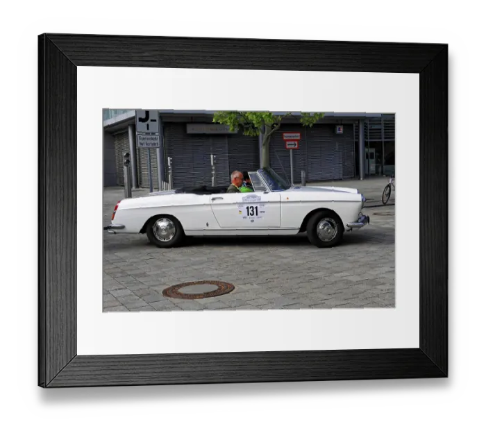 Framed Print : White convertible with an elderly man driving at a classic car event