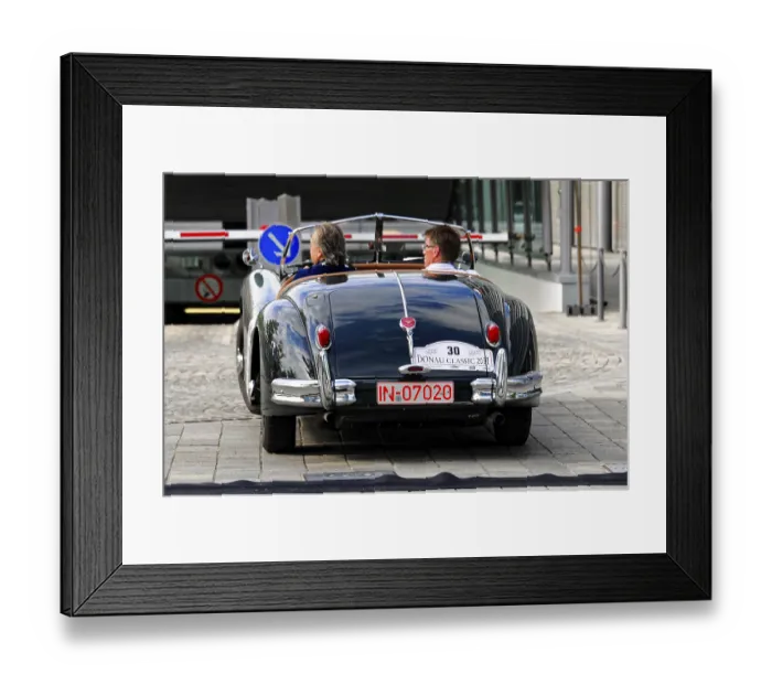 Framed Print : Jaguar XK 140, rear view of a shiny black convertible with two people at a classic car show
