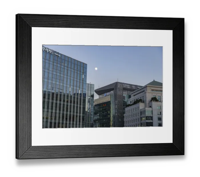 Framed Print : Modern skyscrapers with glass walls under a cloudless evening sky