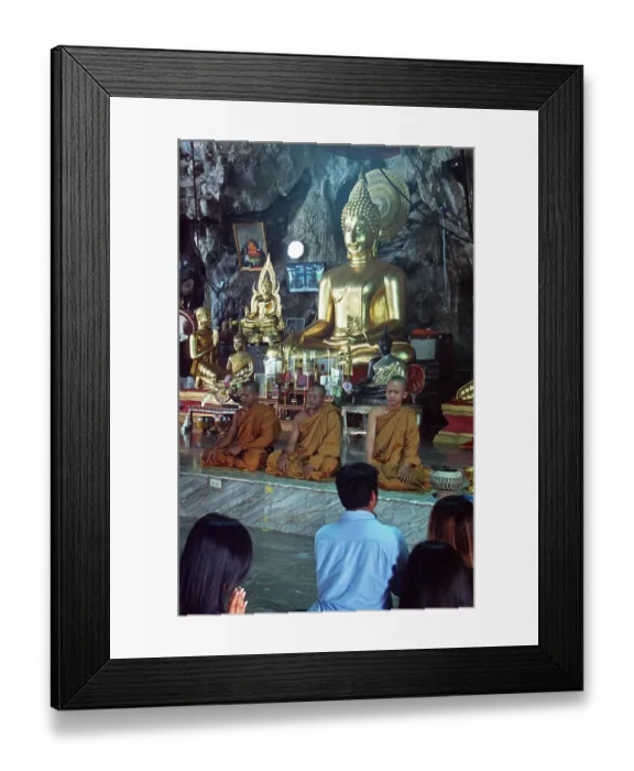 Framed Print : Buddha statue, monks and believers praying Framed Print : Buddha statue, monks and believers praying