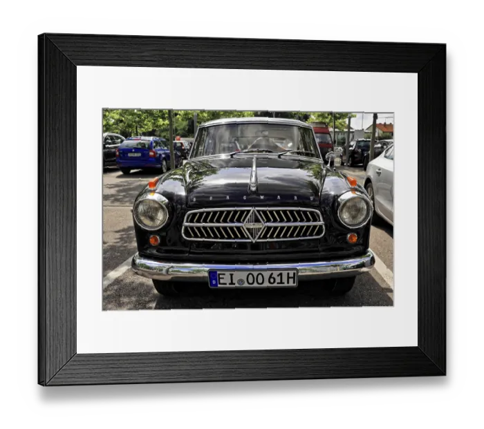 Framed Print : The front of a black classic car with distinctive radiator grille stands on a street Framed Print : The front of a black classic car with distinctive radiator grille stands on a street