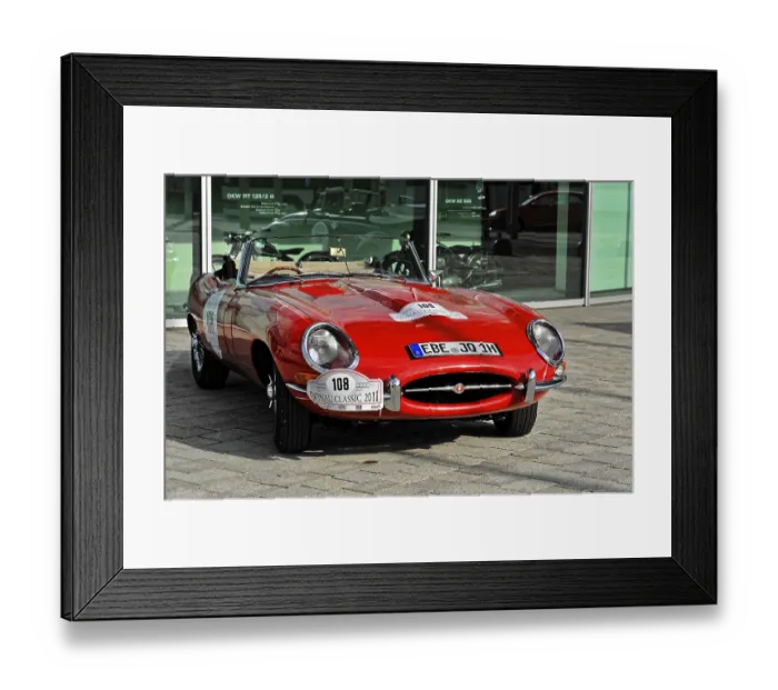 Framed Print : A red classic convertible classic car stands on a paved square Framed Print : A red classic convertible classic car stands on a paved square