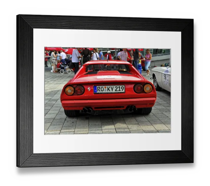 Framed Print : Red Ferrari sports car seen from behind among other classic cars
