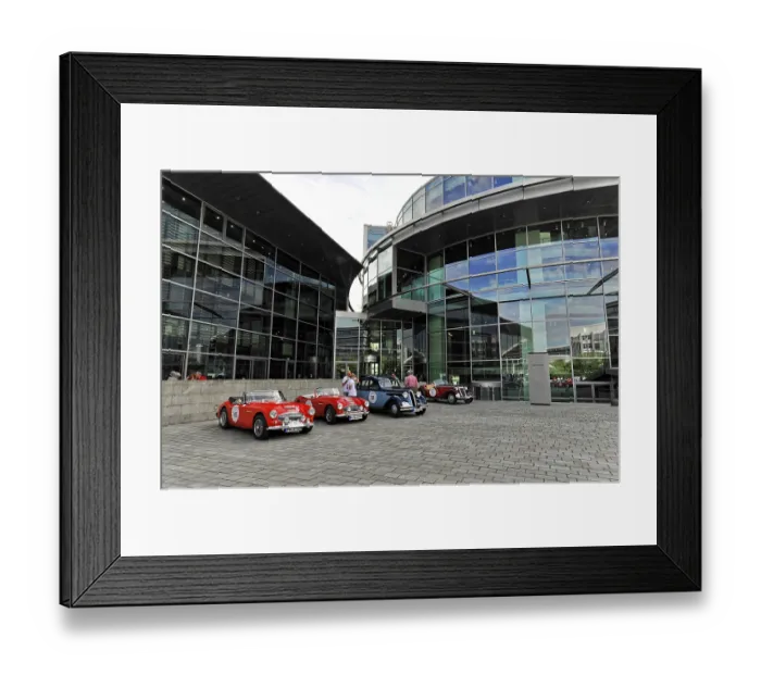 Framed Print : Vintage cars parked in a square in front of modern glass buildings