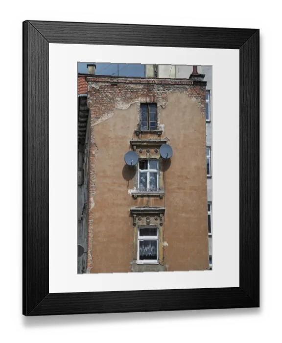 Framed Print : Old tenement house in poor condition with satellite dishes on the wall in Legnica