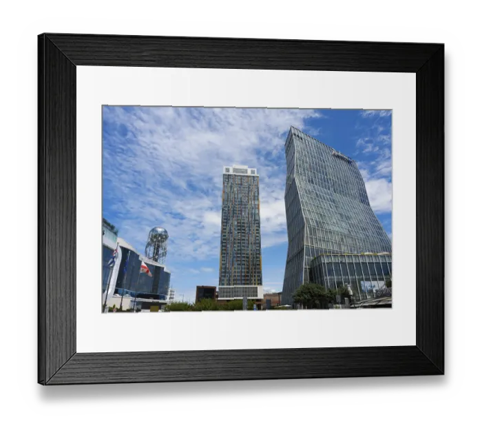 Framed Print : Two modern high-rise buildings with glass facades under cloudy sky Framed Print : Two modern high-rise buildings with glass facades under cloudy sky
