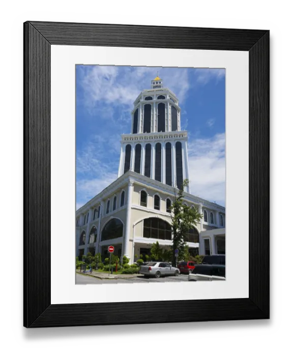 Framed Print : A magnificent tower of blue and white architecture rises into the sunny sky of a busy city
