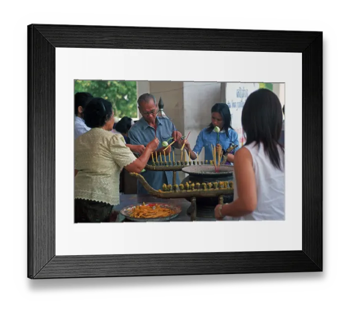 Framed Print : Believers light candles in front of the temple with the Buddha statue Phra Mongkhonbophit