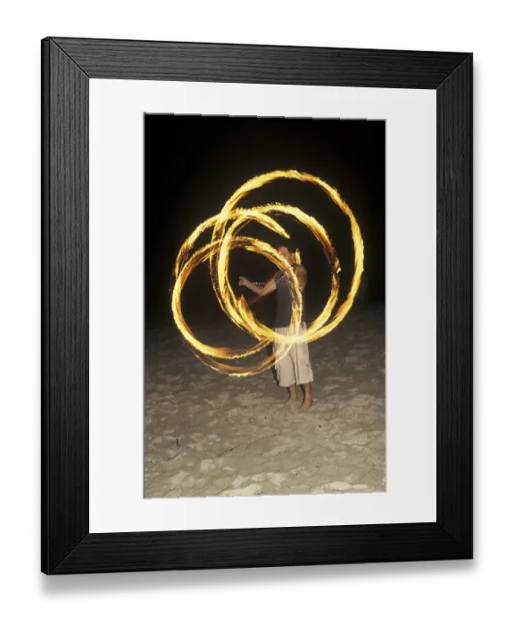Framed Print : A man waves burning torches on the beach of Coral Beach Resort on the island of Ko Lanta
