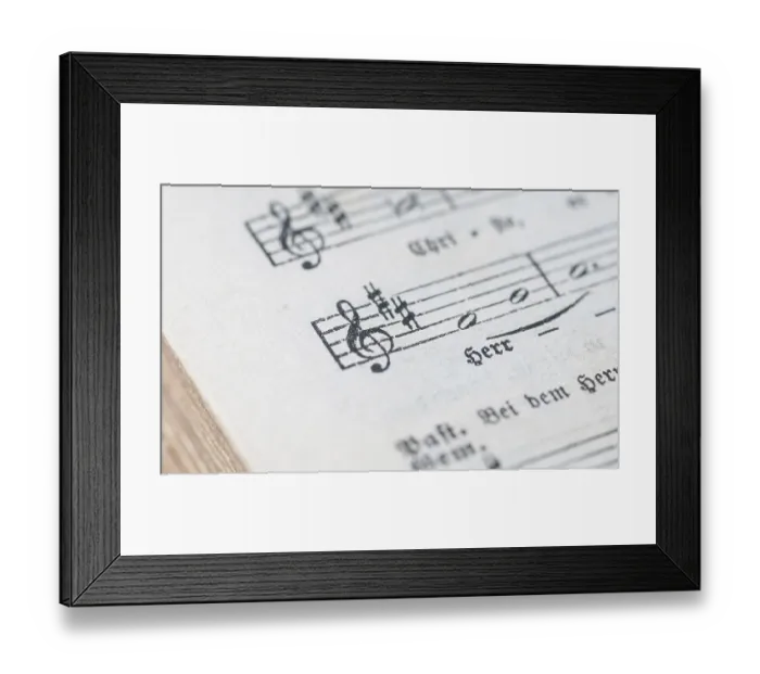 Framed Print : Close-up of a sheet music with musical symbols and text in black and white