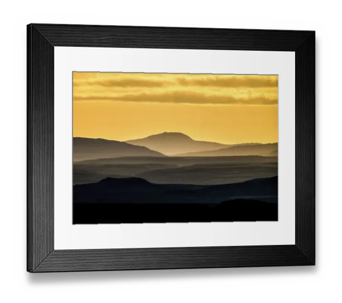 Framed Print : Silhouettes of mountains at sunset with yellow sky