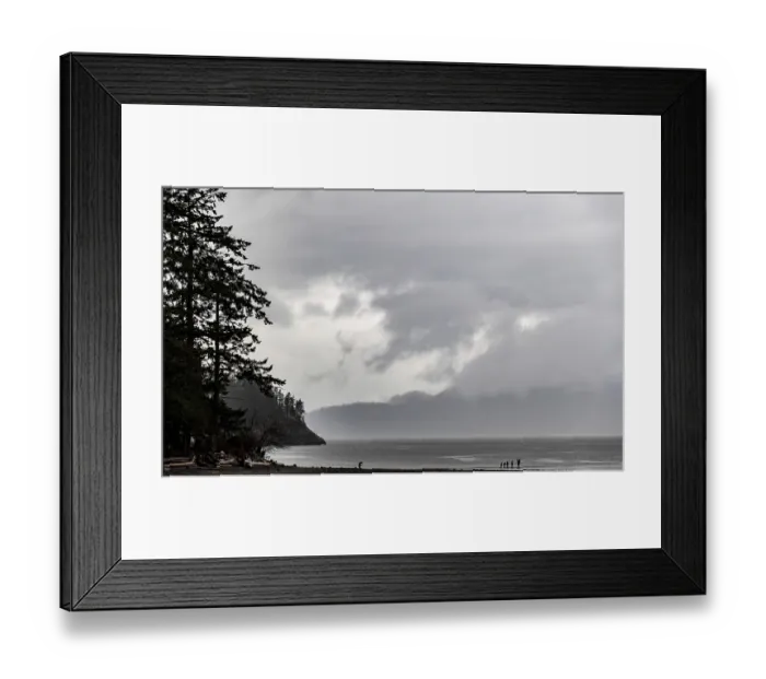 Framed Print : Dark, moody beach with misty mountains and trees framing the scene along the Lower Mainland of British Columbia Framed Print : Dark, moody beach with misty mountains and trees framing the scene along the Lower Mainland of British Columbia