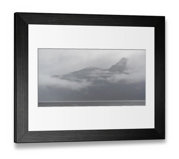 Framed Print : Fog-covered mountain peak rising above an overcast ocean backdrop along the Lower Mainland of British Columbia
