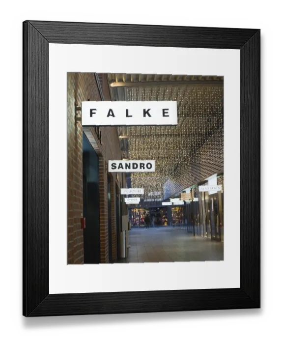 Framed Print : Passage with decorative fairy lights and shops such as Falke and Sandro