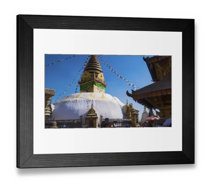 Framed Print : Buddhist stupa with prayer flags surrounded by visitors under a bright blue sky Framed Print : Buddhist stupa with prayer flags surrounded by visitors under a bright blue sky