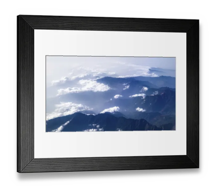 Framed Print : Sublime mountain landscape with clouds and clear sky in a large panorama Framed Print : Sublime mountain landscape with clouds and clear sky in a large panorama