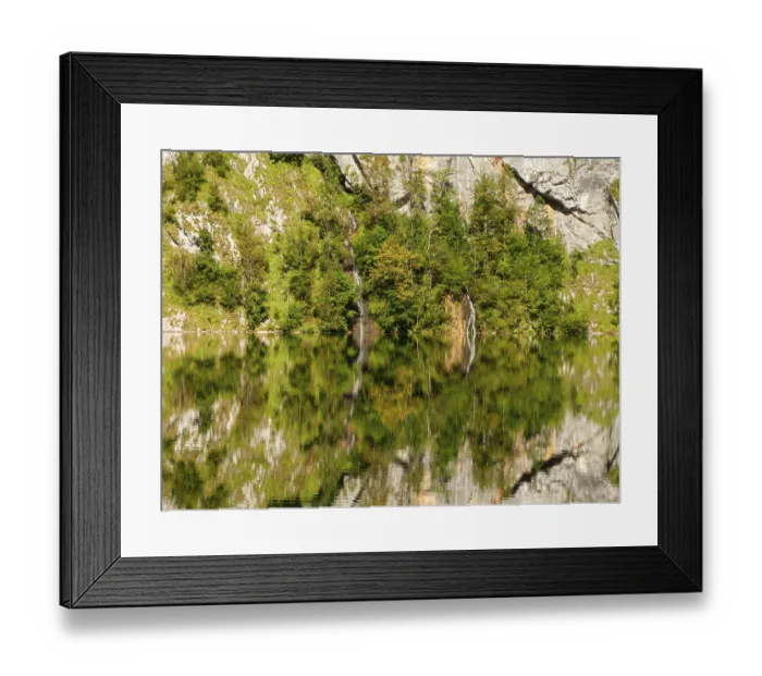 Framed Print : Mountain forest, small waterfall and rock walls are reflected in Obersee
