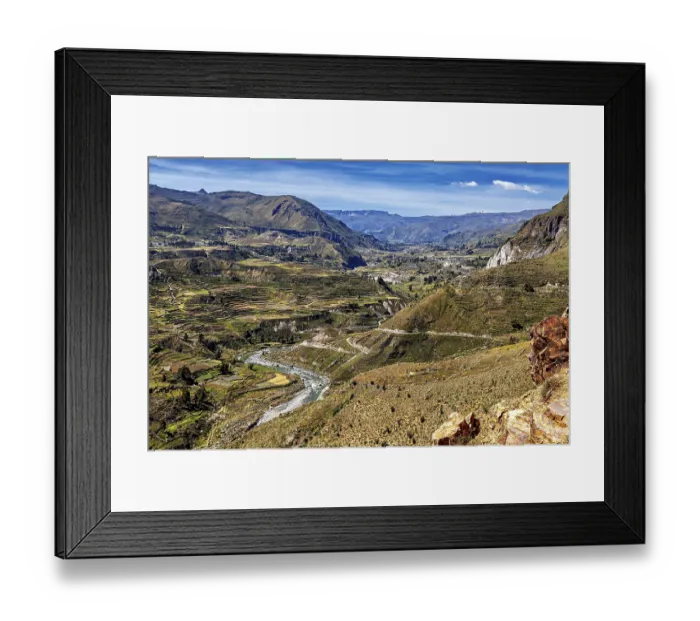 Framed Print : River valley with terraces and mountains under sweeping skies Framed Print : River valley with terraces and mountains under sweeping skies